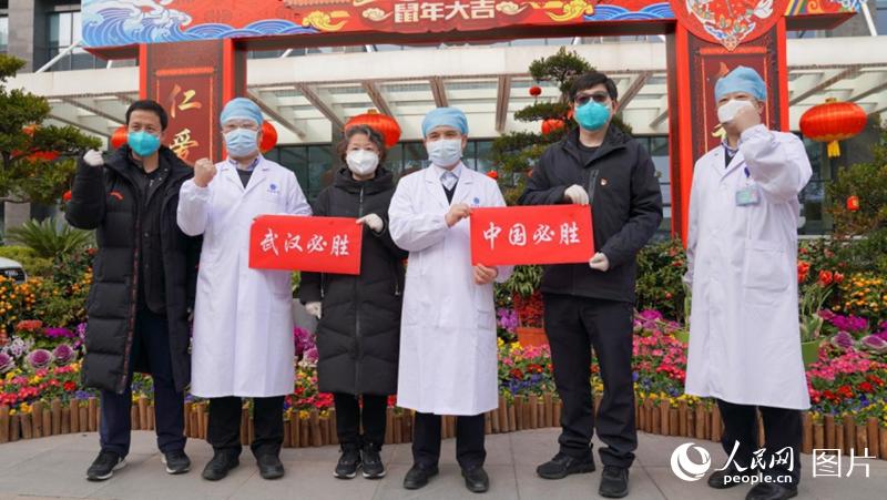 医护人员手持“必胜”标语合影留念。韩基琛 摄